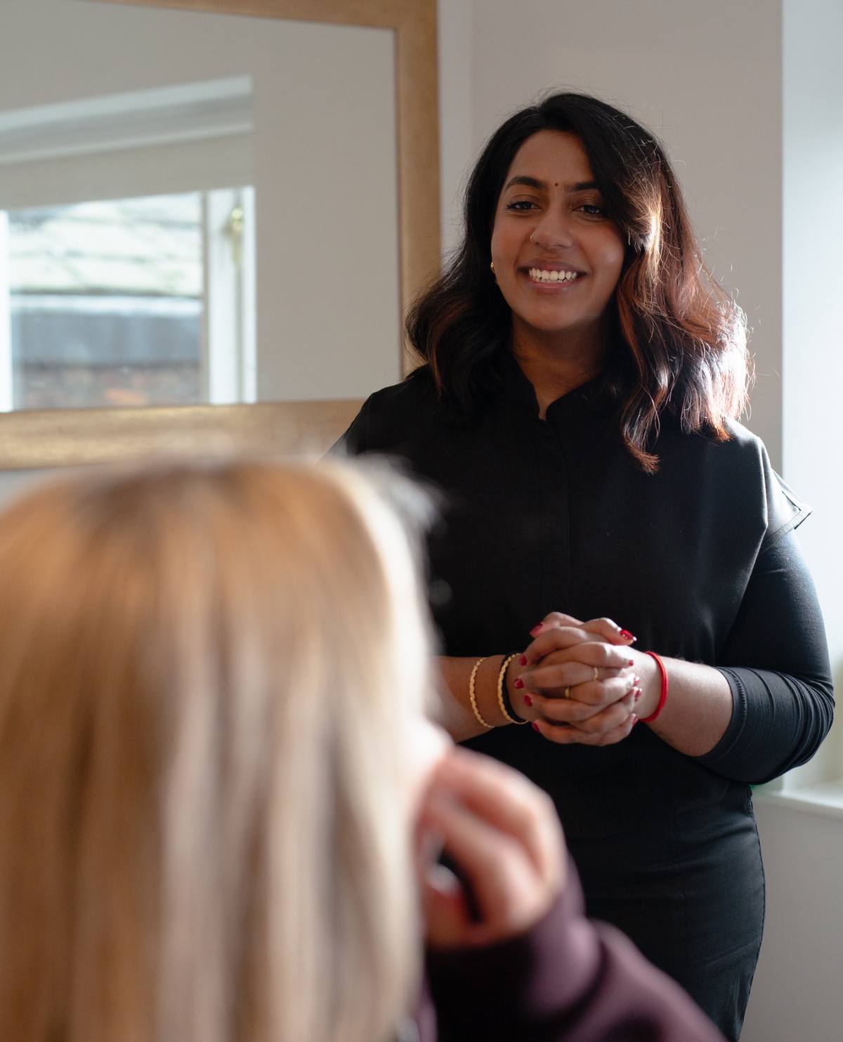 Dr Misha in consultation with a client at Revitalise Aesthetics Liverpool